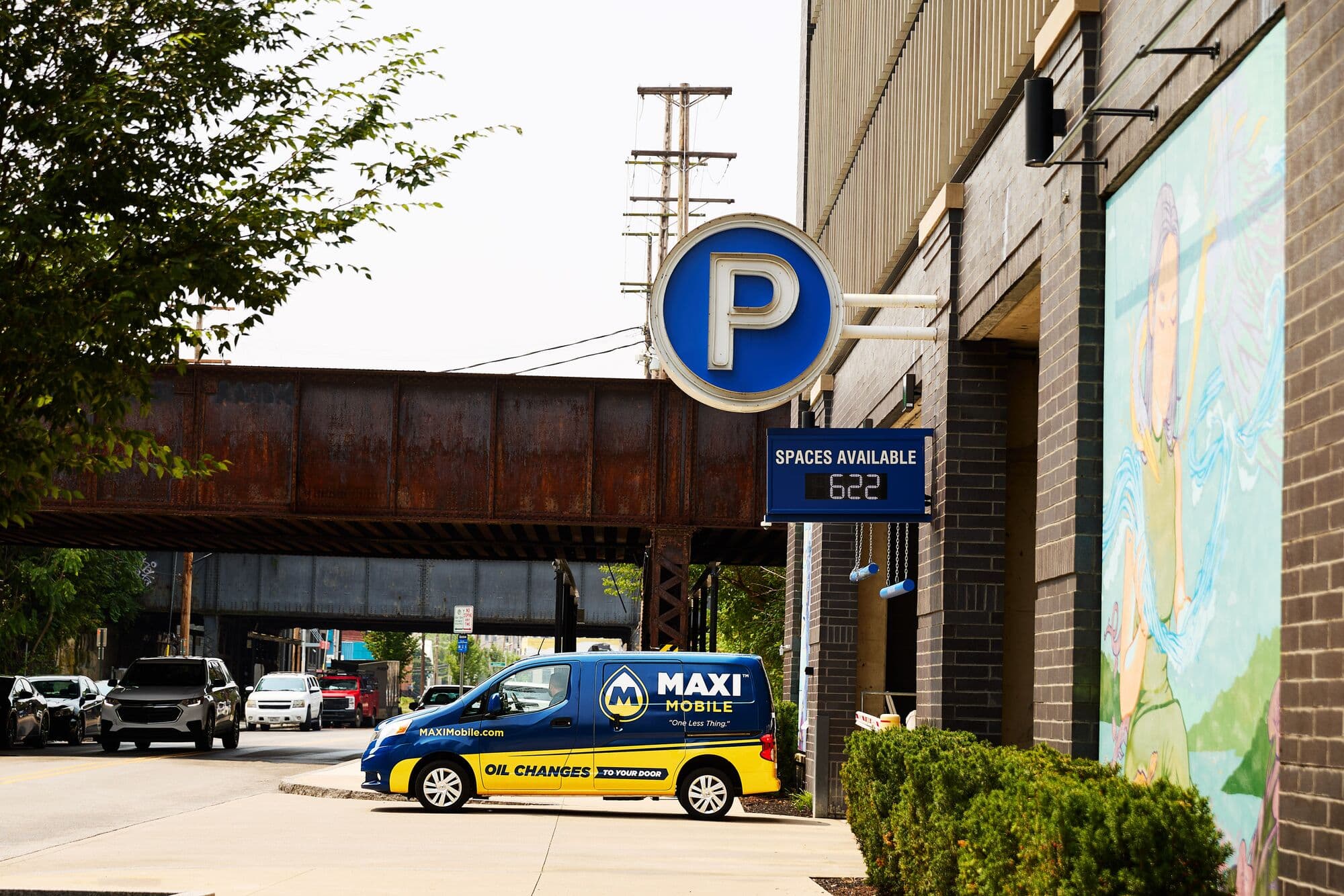 A MAXI Mobile van parked outside a downtown parking garage where people already leave their cars