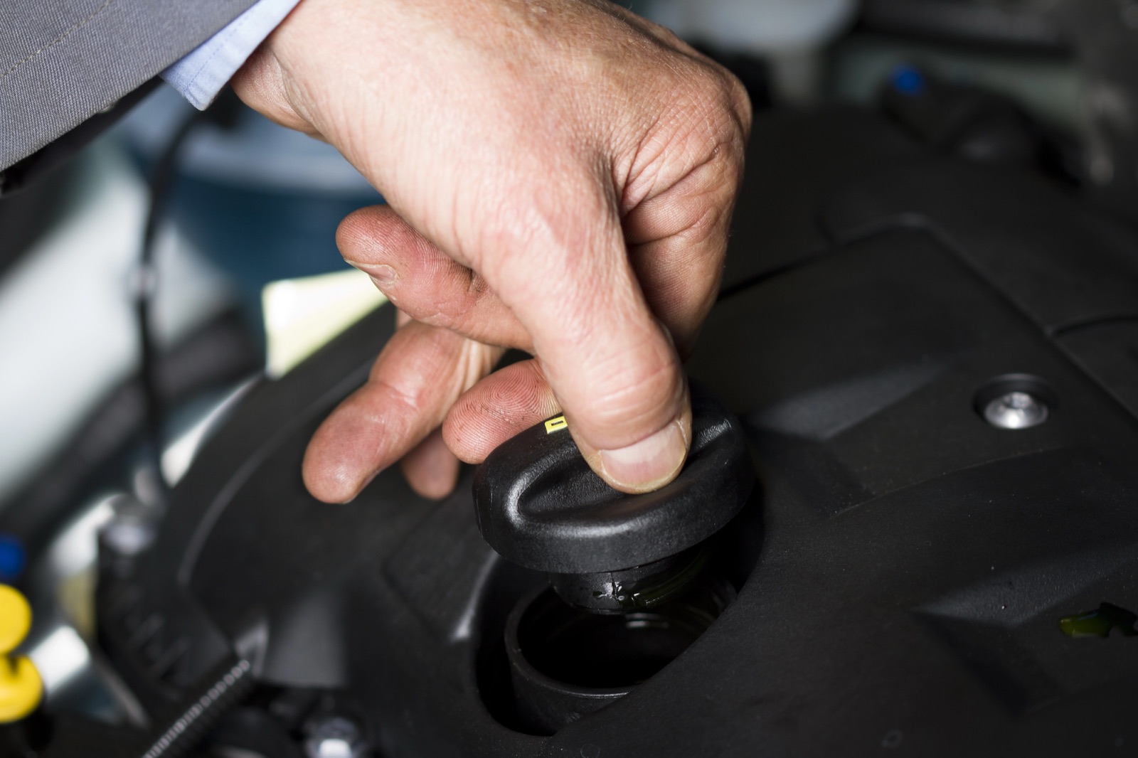 Removing the oil filler cap during a routine oil change