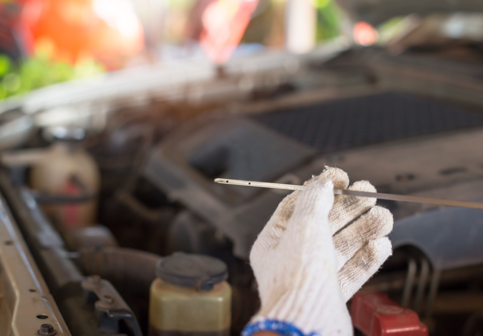 Checking the oil level on the dipstick during routine service