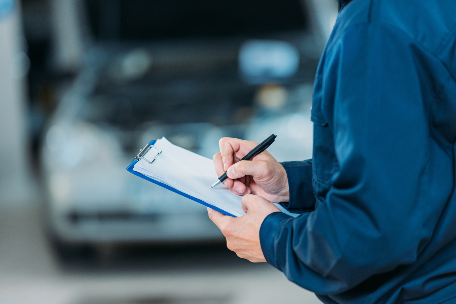 Technician documenting a completed service on a clipboard
