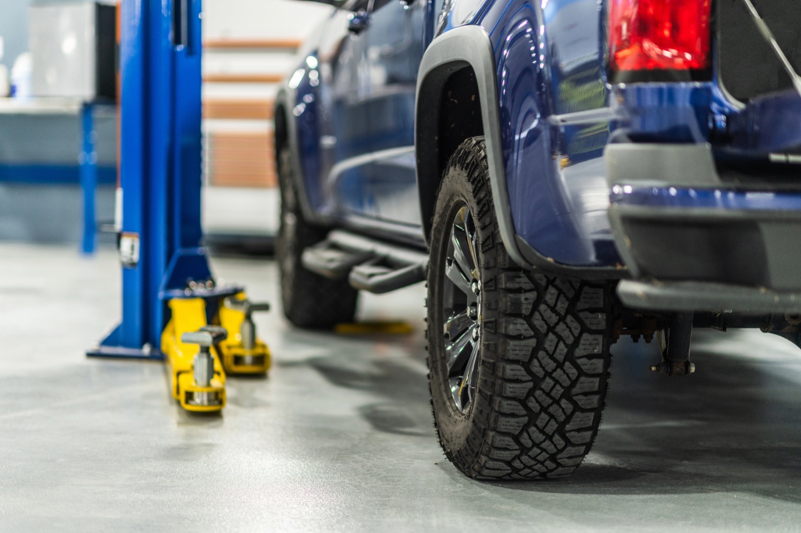 Pickup truck getting new tires in a service bay